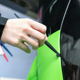 FOSHIO roll next to hand for scale, illustrates 50m length and project coverage