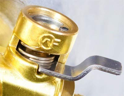 Fumoto F-107SX draining oil into pan illustrating clean, controlled oil flow