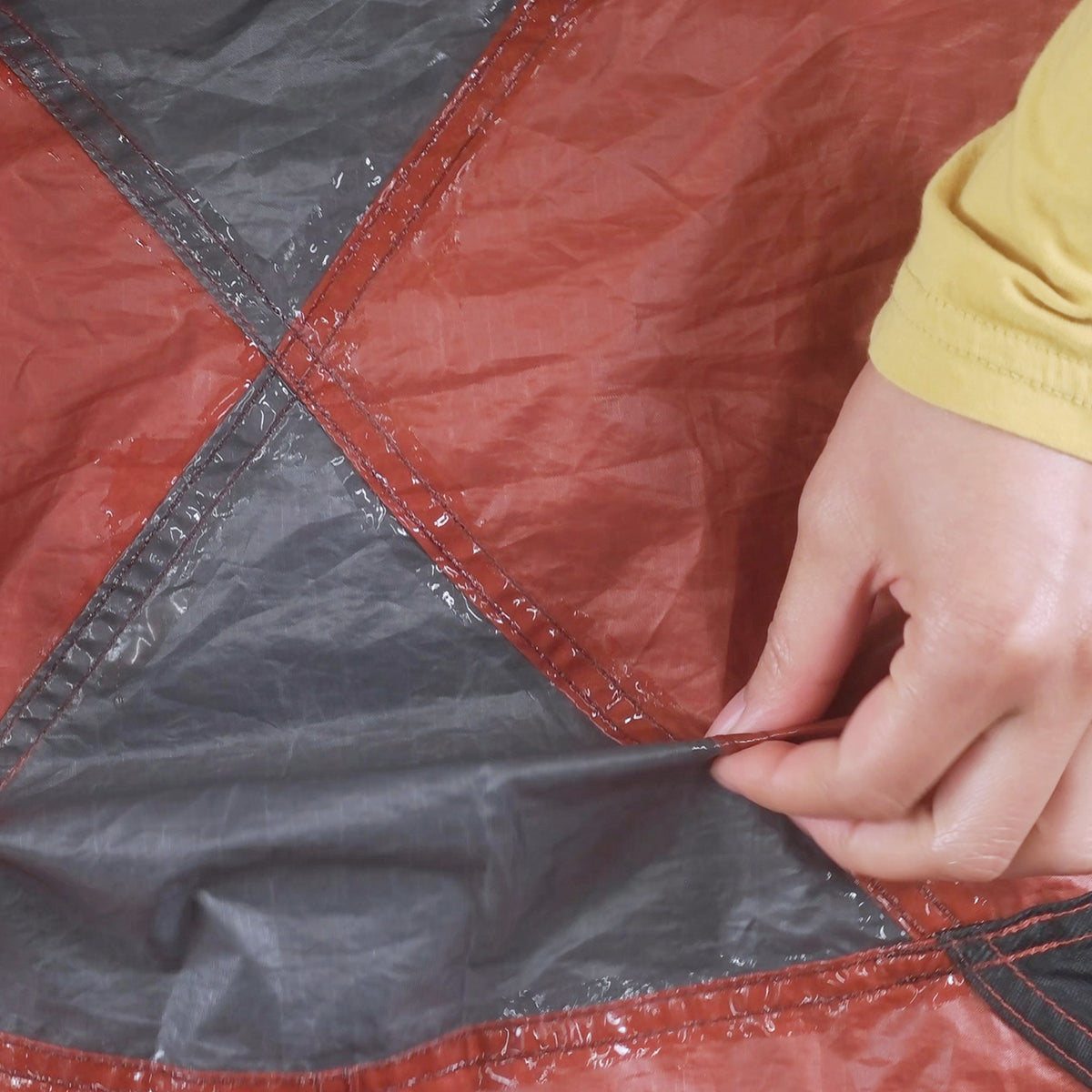 GEAR AID sealing a tent seam outdoors to restore waterproof protection