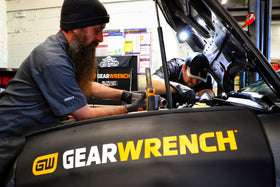 GEARWRENCH fender cover in use under hood protecting paint and holding tools securely