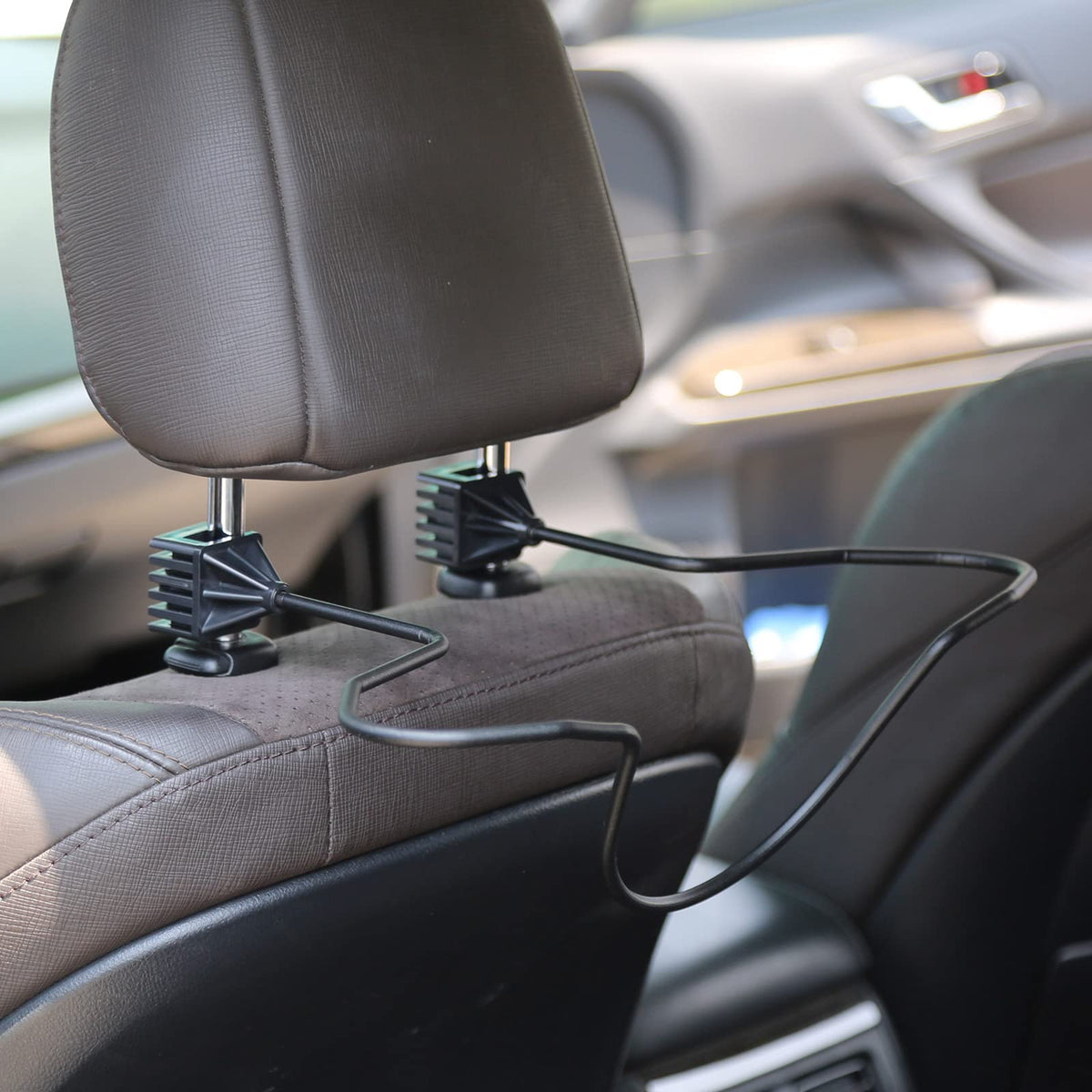 GEEDAR holding a cowboy hat to maintain shape during drives