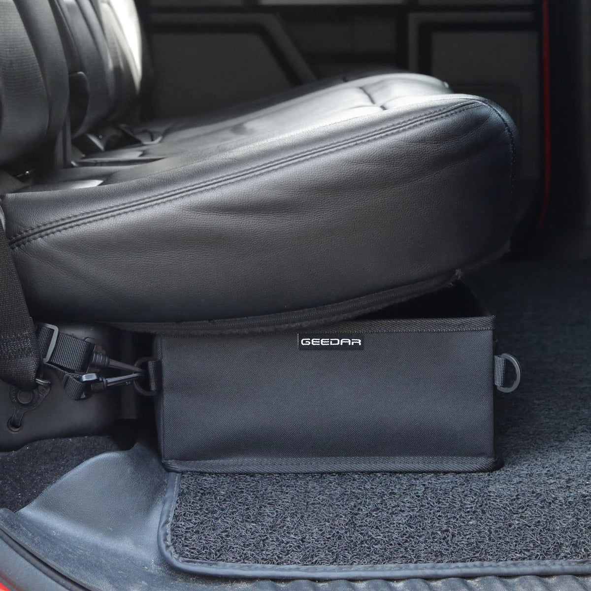 GEEDAR folded flat under a seat showing space-saving storage benefit