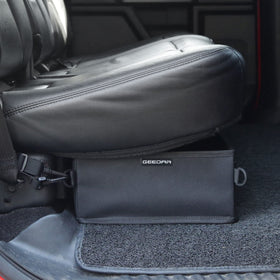 GEEDAR folded flat under a seat showing space-saving storage benefit