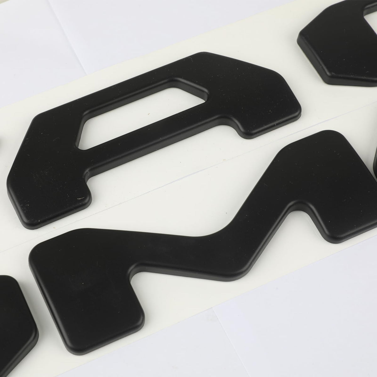 Generic view of letter adhesive backing during installation showing secure bond benefit