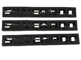 Generic emblems installed on a Silverado tailgate showing restored appearance benefit