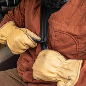 Gerber tool in hand being used to slice seatbelt showing one-handed operation
