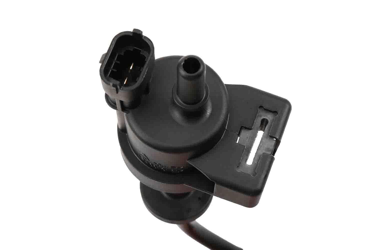 GM Genuine Parts purge valve next to ruler showing compact size for easy replacement