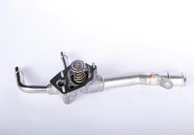 GM Genuine Parts thermostat housing next to ruler for scale demonstrating correct OE dimensions