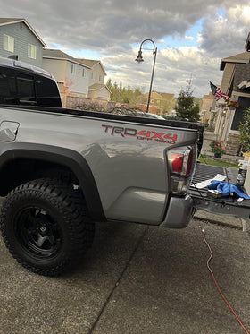 GO-GO.GROUP decal installed on pickup bedside showing seamless paint integration and finish
