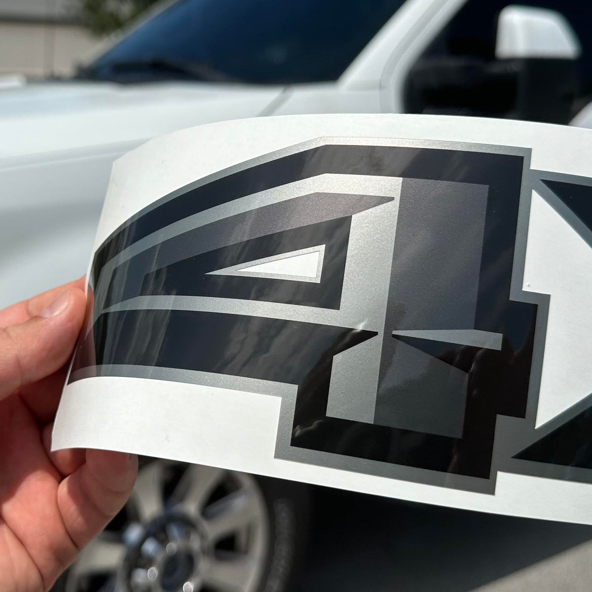 GOLD HOOK decal on truck in driveway demonstrating durable outdoor finish