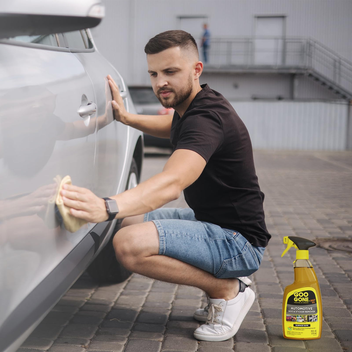 Goo Gone spraying on car bumper demonstrating targeted application for stubborn residue