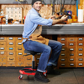 Goplus stool next to standard chair showing compact footprint and stability