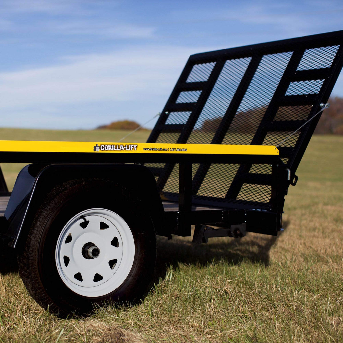 GORILLA-LIFT next to measuring tape, showing adjustable fit for various tailgate sizes