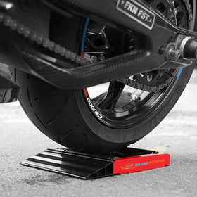 GRAND PITSTOP scale comparison with helmet showing compact storage benefit