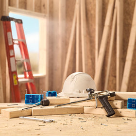 Great Stuff Pro on a jobsite bench with tools illustrating contractor-ready durability and efficiency