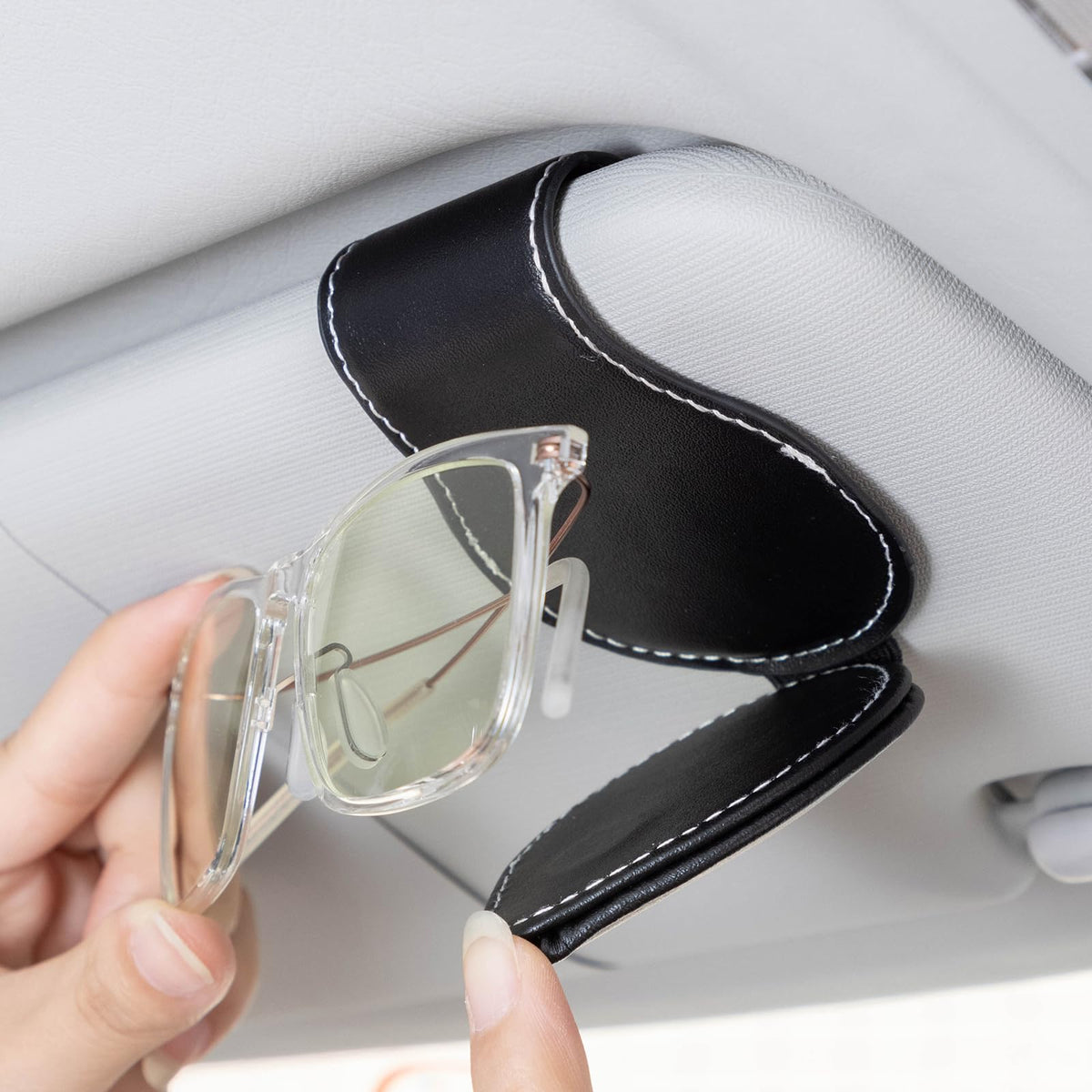GshionLyfe holding sunglasses on visor for quick one-handed access benefit