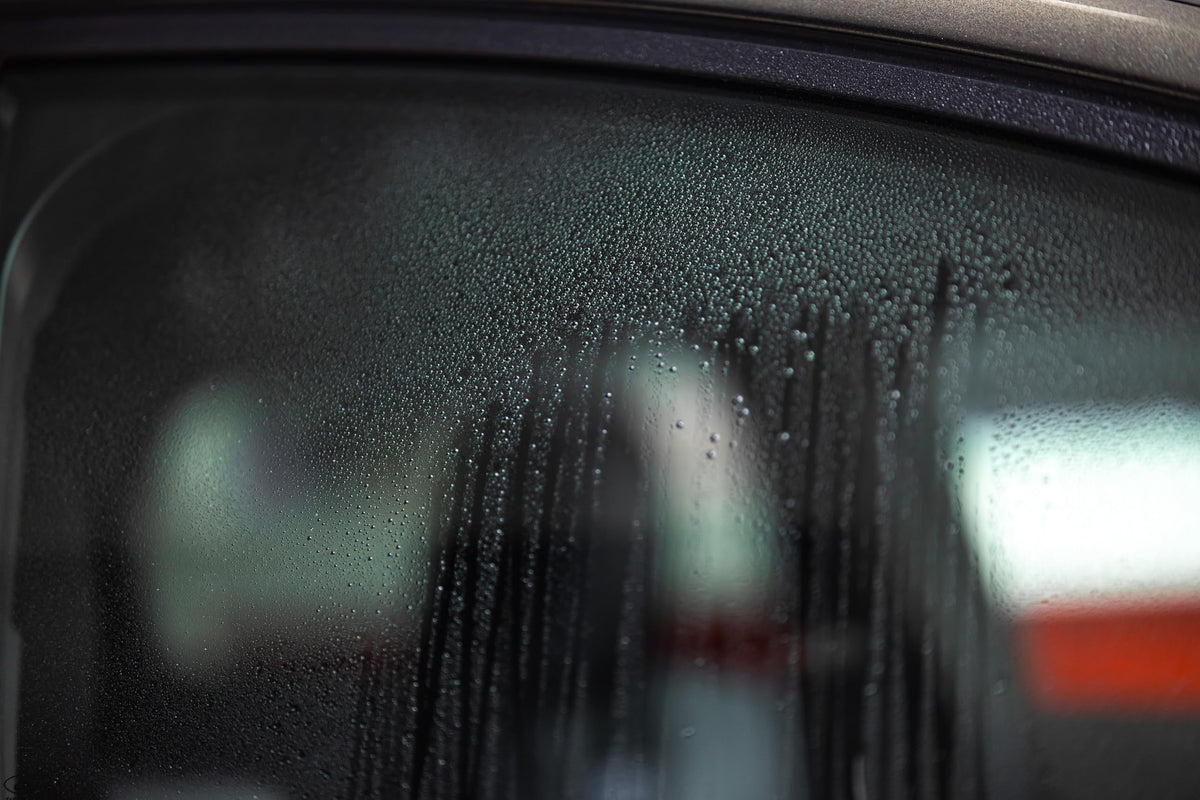 Gtechniq G5 on car mirror in use reducing water streaks for safer driving