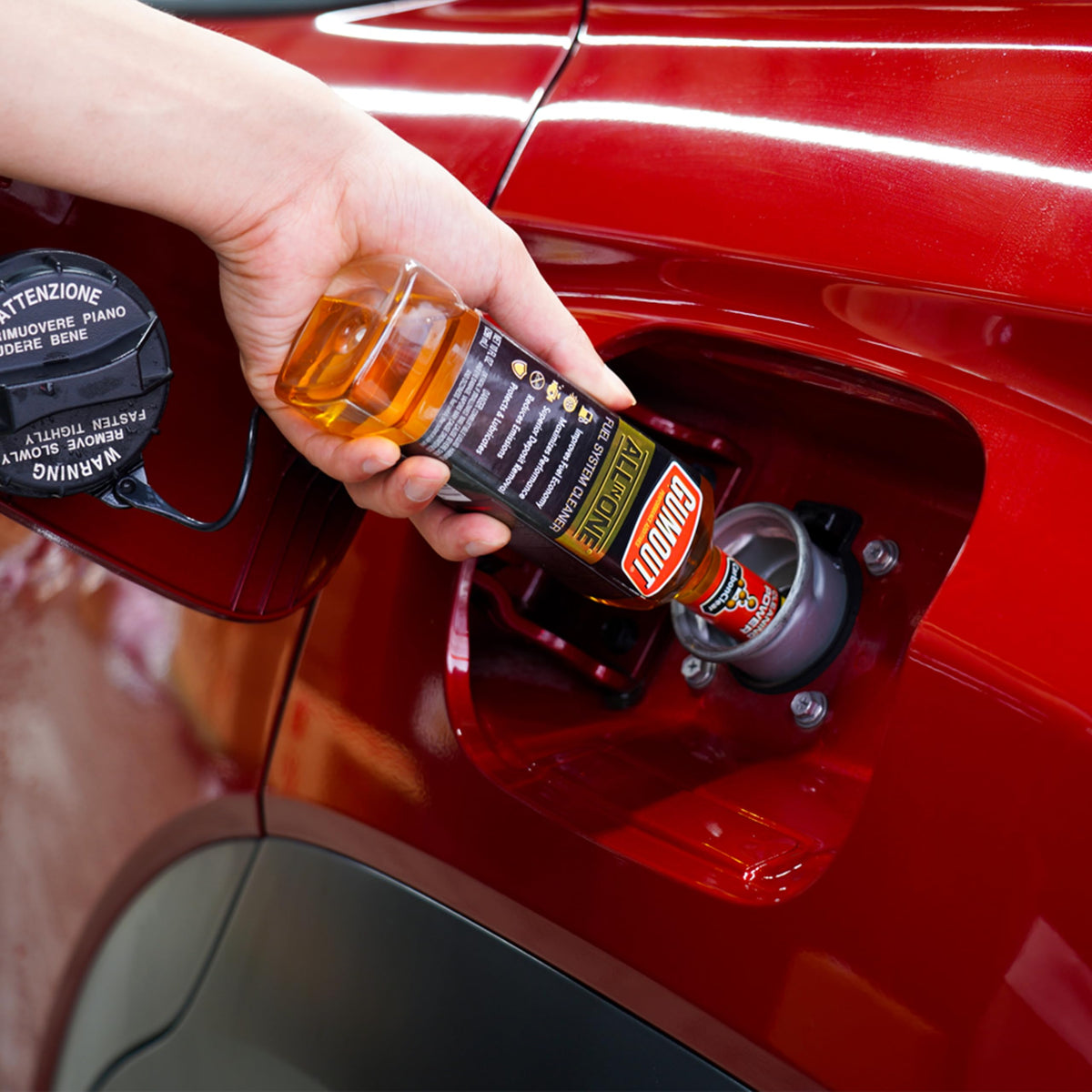 Gumout pouring into fuel filler demonstrating easy application and maintenance