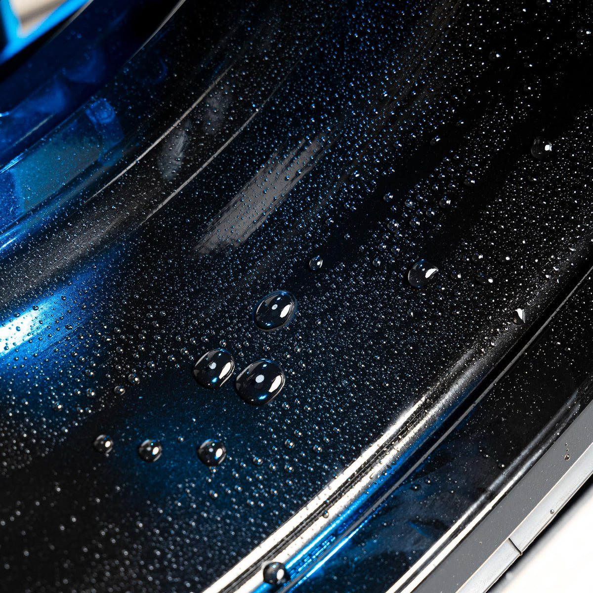 Gyeon hydrophobic beading on rim illustrating water‑shedding and easier washing benefit