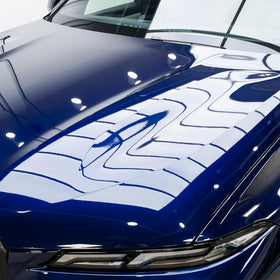 Paint panel with MOHS EVO applied showing slick surface and improved reflectivity