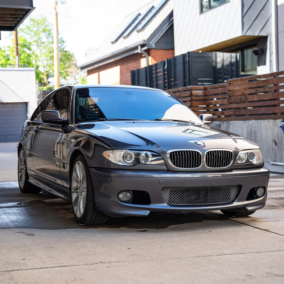 Gyeon in lifestyle scene washing a car to restore hydrophobic bead and sheen
