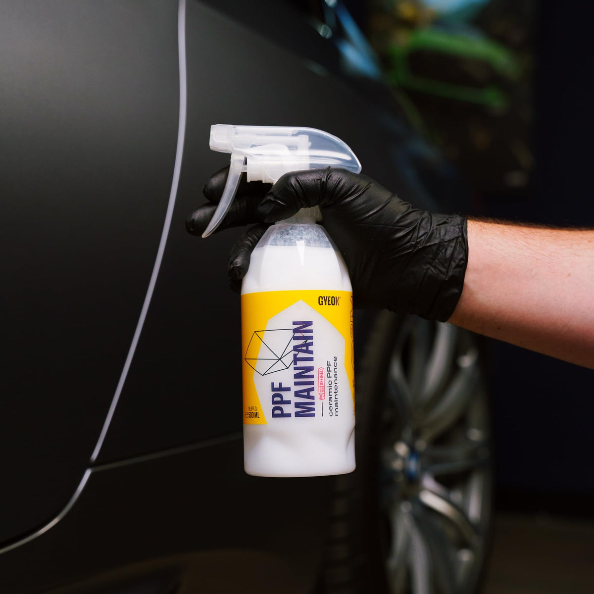 Gyeon bottle on a clean detailed car hood highlighting showroom-ready finish and simplicity