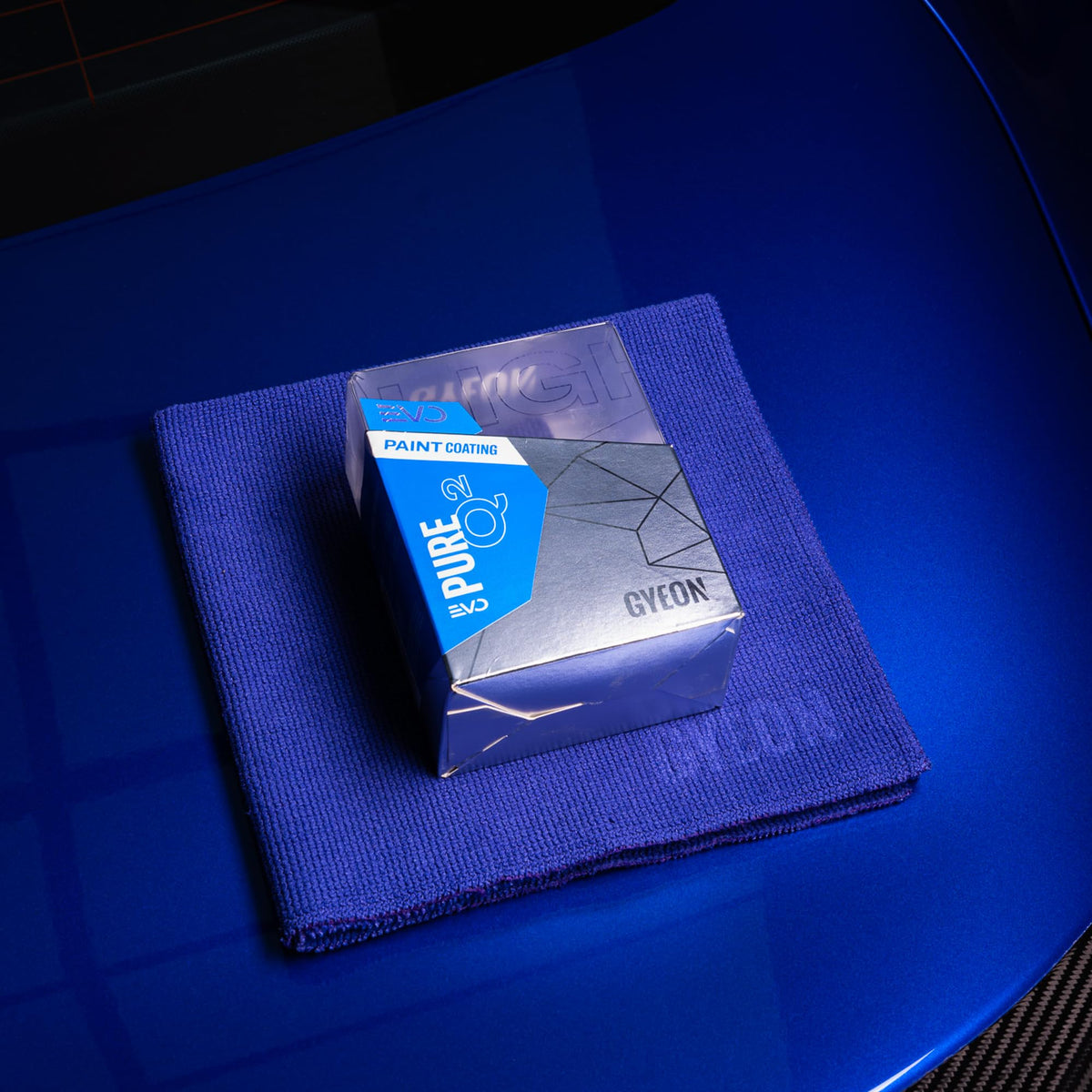 Gyeon Pure glossy paint panel reflecting light to show deep candy-like gloss