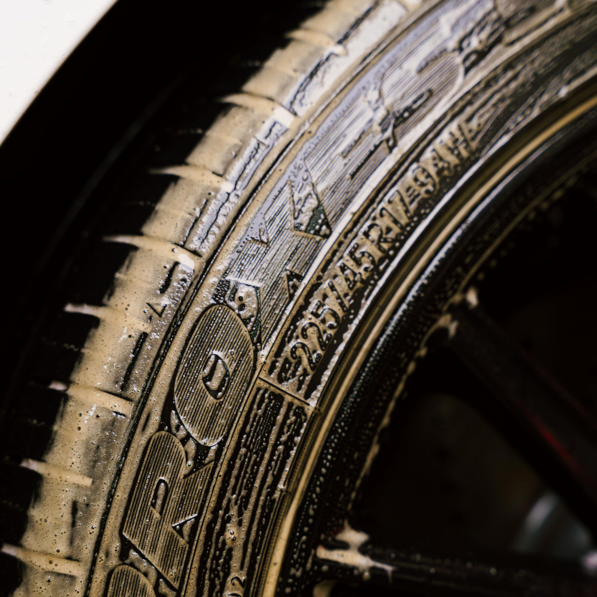 Gyeon tire cleaner in use spraying a tire to dissolve grime quickly