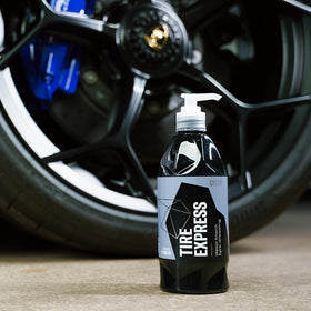 Spray application of Gyeon on a damp tire showing fast absorption benefit