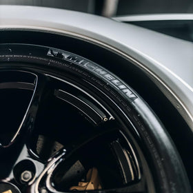 Gyeon on a parked car tire demonstrating long‑lasting satin appearance