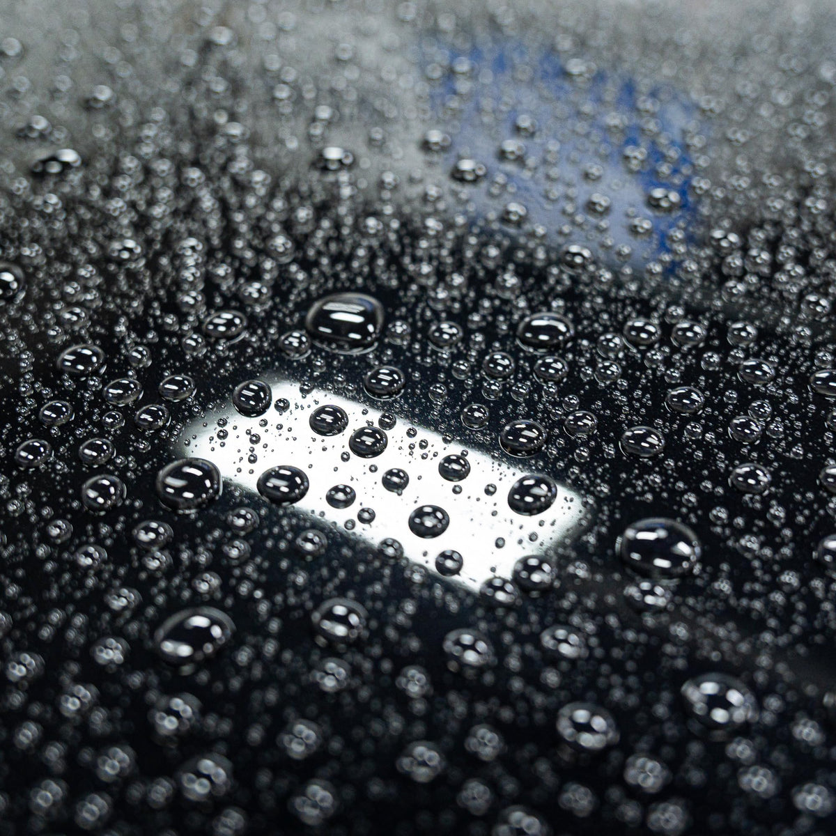 Gyeon Wet Coat being sprayed on a wet car panel to speed up rinse-off maintenance