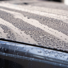 Gyeon treated wheel before and after showing cleaner runoff and gloss