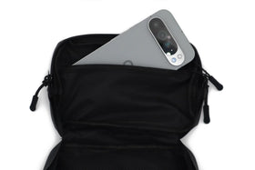 Havoc Racing bag next to phone to show 8x5x2 inch capacity and fit