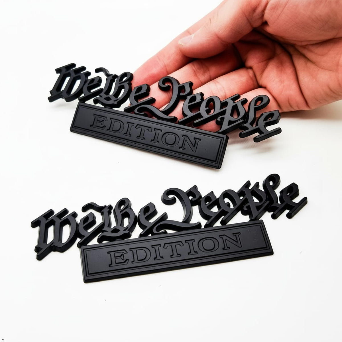HJKK emblem front view showing matte-black patriotic badge and premium look
