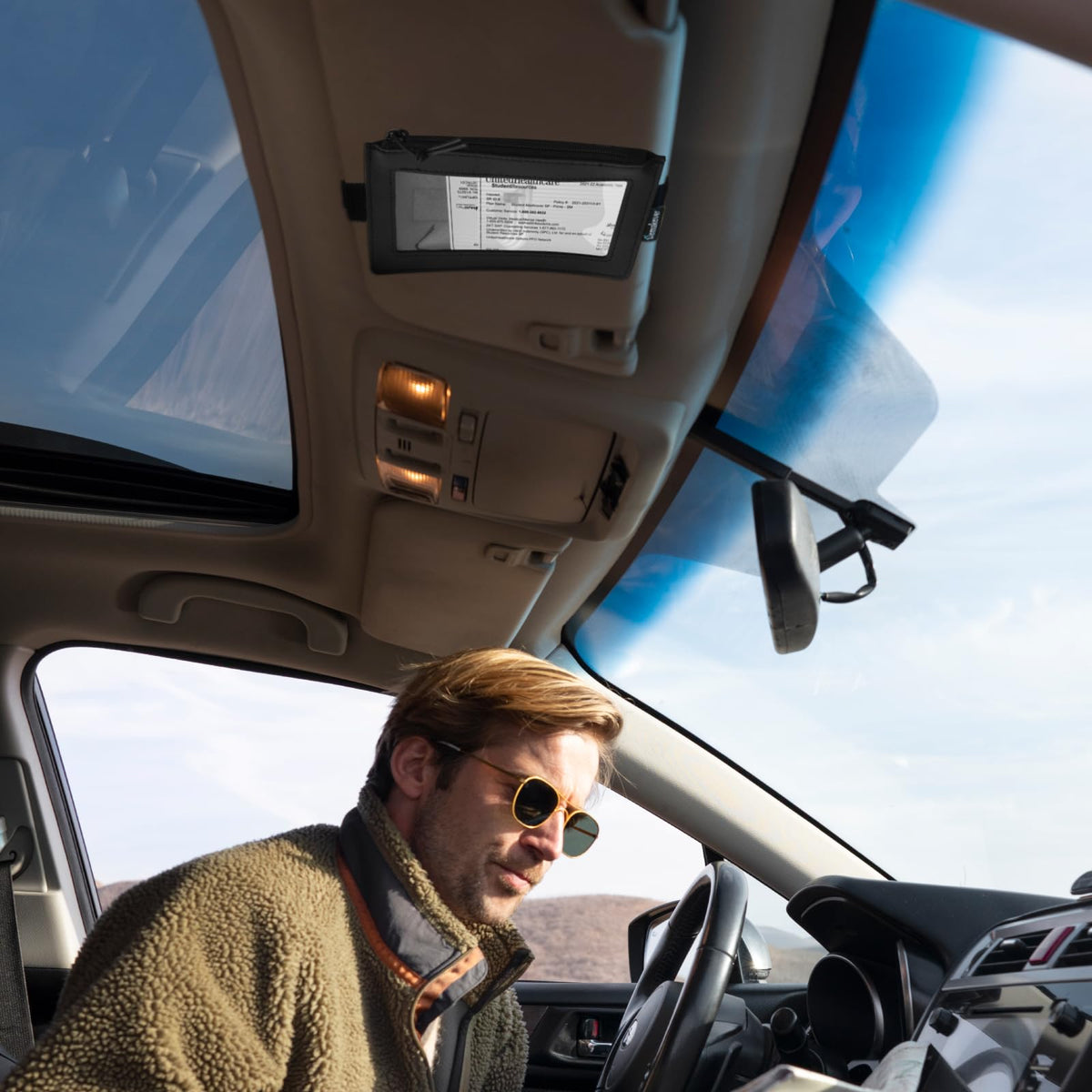 Homakover installed on car visor demonstrating unobstructed driving view