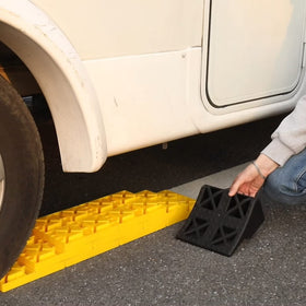 Homeon Wheels kit in use under RV showing practical campsite stability