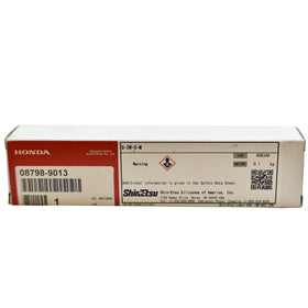 Honda grease tube beside ruler showing compact, workshop-friendly size
