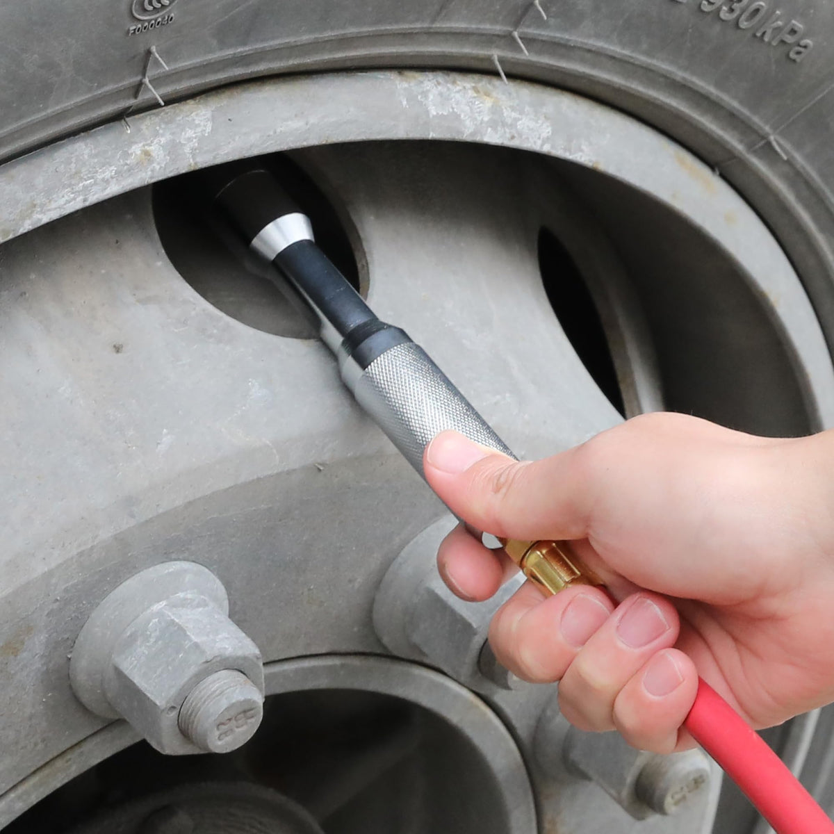 HOOTSUM in use on off-road tire demonstrating hands-free inflation on large-bore valve
