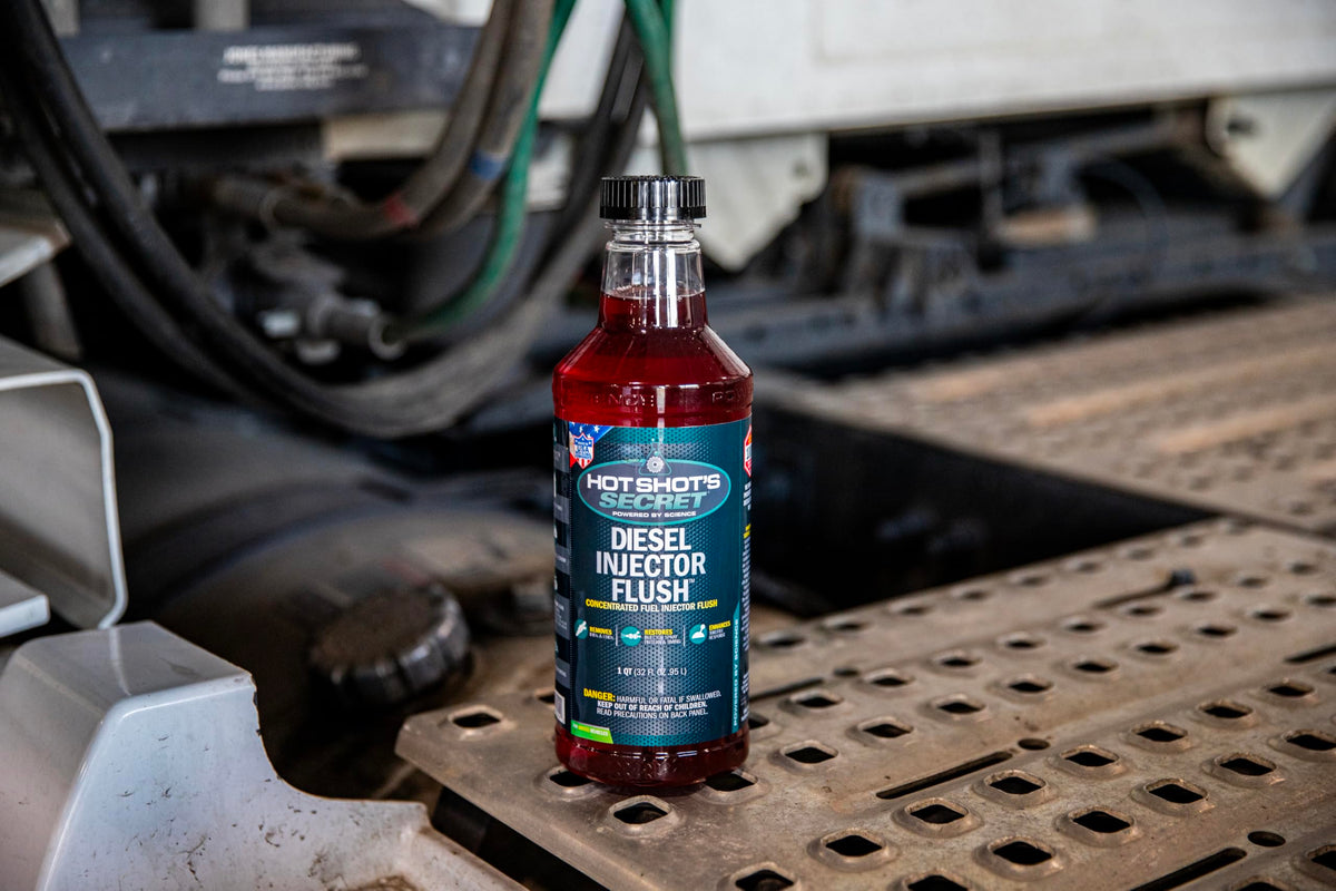 Hot Shot's Secret bottle on a workshop bench showing fleet maintenance benefit