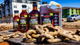 Hot Shot's Secret bottle on garage workbench with truck in background for maintenance