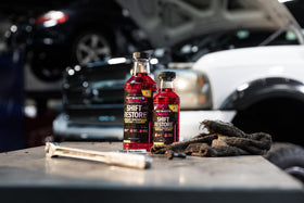 Hot Shot's Secret bottle on garage workbench demonstrating easy application
