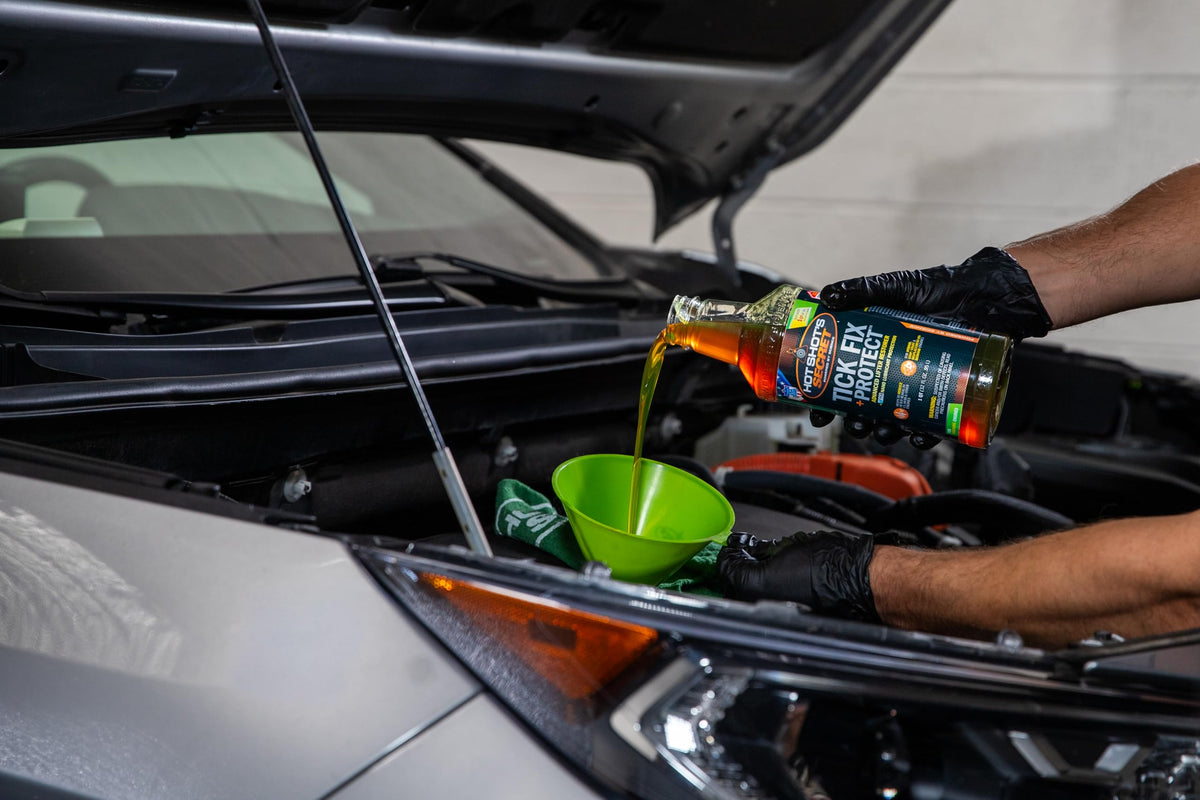 Hot Shot's Secret bottle next to open engine bay showing in-use benefit