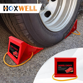 HOXWELL chock next to hand showing compact size and portable convenience