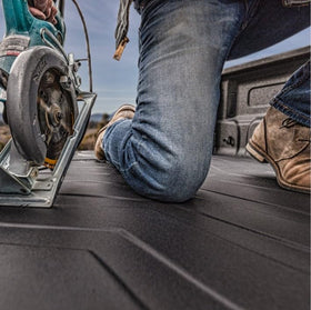 Husky Liners next to toolbox showing scale and fit for cargo protection