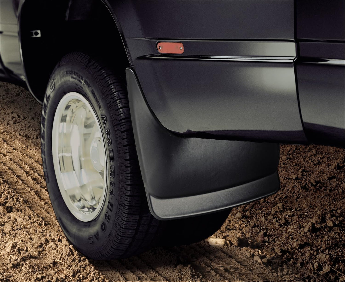 Husky Liners mud guard beside tire showing scale and full coverage