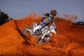 Husqvarna oil change kit in use under a bike demonstrating easy, OEM-compliant service