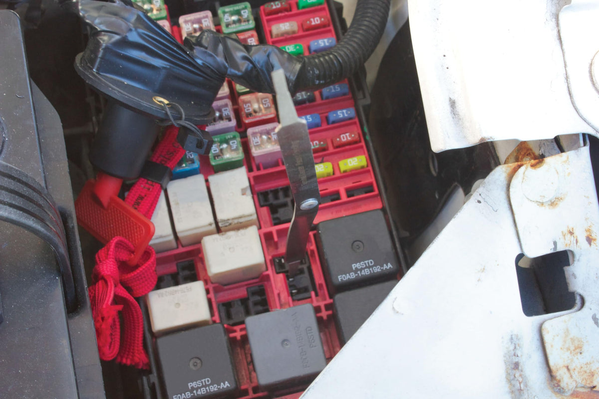 Innovative Products of America technician using chaser on trailer plug to prevent intermittent faults