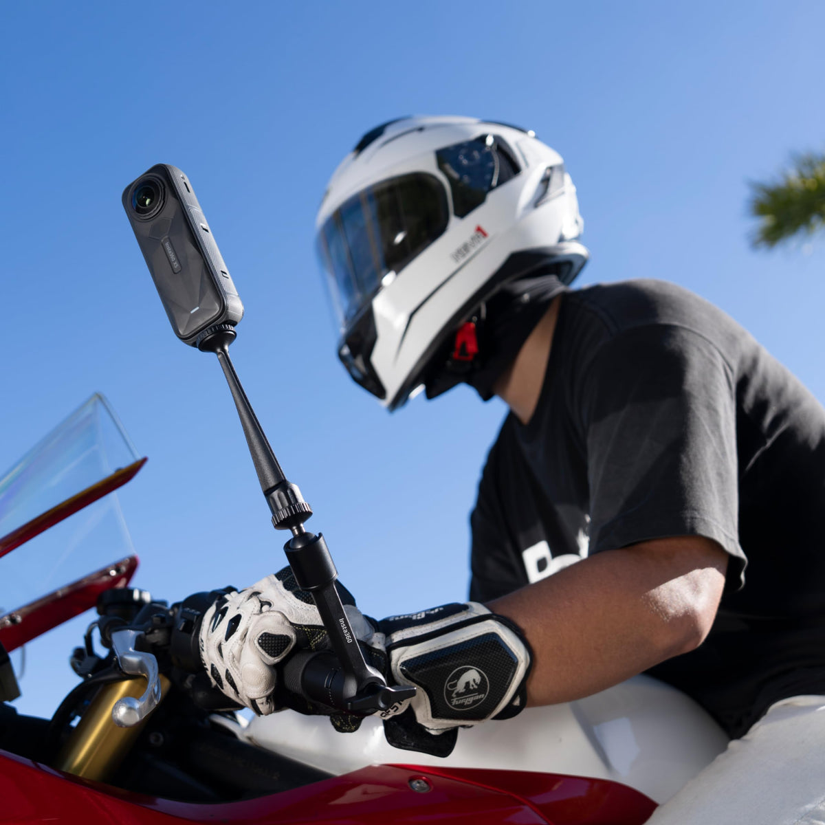 Insta360 Magic Arm size comparison with a gloved hand showing compact portability