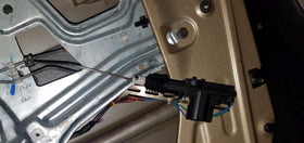 InstallGear actuator installed inside vehicle door illustrating secure fit and smoother locking