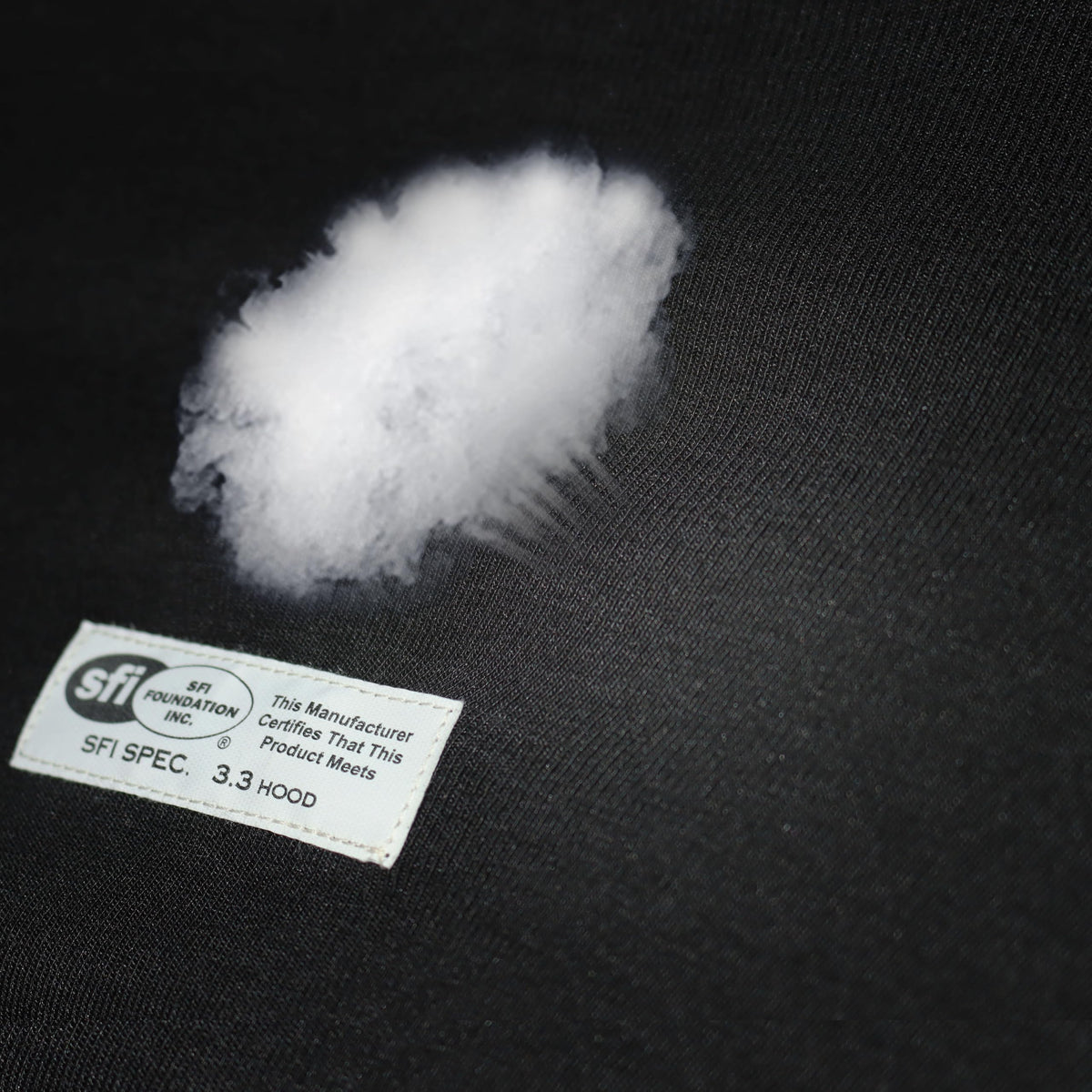 J-RACING label close-up showing SFI 3.3 certification for trusted flame-resistant benefit